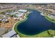 Beautiful aerial view of a community lake, playground, and nearby neighborhood at 25511 S 227Th St, Queen Creek, AZ 85142