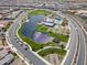 Aerial view showcasing a beautiful neighborhood lake, park, and community pool at 25511 S 227Th St, Queen Creek, AZ 85142