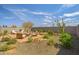 Backyard with brick patio, seating area, mature trees, and desert landscaping offering privacy and tranquility at 25511 S 227Th St, Queen Creek, AZ 85142
