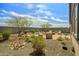 Tranquil backyard oasis with desert landscaping, a stone garden, and an inviting brick patio with stylish seating at 25511 S 227Th St, Queen Creek, AZ 85142