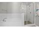 Modern bathroom showcasing a tiled shower, soaking tub, and elegant fixtures at 25511 S 227Th St, Queen Creek, AZ 85142