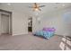 Large bedroom with ceiling fan and attached bathroom entrance, perfect for convenience at 25511 S 227Th St, Queen Creek, AZ 85142
