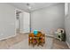 Bright bedroom with a wooden table set, rug, and toy kitchen for the  at 25511 S 227Th St, Queen Creek, AZ 85142