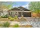 Inviting single-story home showcasing stone detail, desert landscaping, and a two-car garage at 25511 S 227Th St, Queen Creek, AZ 85142