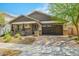 Attractive single-story home featuring stone accents, desert landscaping, and a brick driveway at 25511 S 227Th St, Queen Creek, AZ 85142