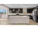 Modern kitchen featuring a large island, dark cabinetry, stainless steel appliances, and stylish pendant lighting at 25511 S 227Th St, Queen Creek, AZ 85142