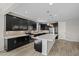 Stylish kitchen featuring dark cabinetry, a center island with seating, and sleek appliances at 25511 S 227Th St, Queen Creek, AZ 85142