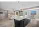 Open concept living features a stylish kitchen with an island, stainless appliances, and an adjacent living and dining area at 25511 S 227Th St, Queen Creek, AZ 85142