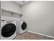 Laundry room featuring a washer, dryer, and a shelf at 25511 S 227Th St, Queen Creek, AZ 85142