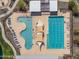 Aerial view of a community pool featuring lap lanes, a splash pool, covered seating and lounging chairs at 25511 S 227Th St, Queen Creek, AZ 85142