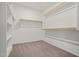 Spacious walk-in closet with built-in shelving and carpeted floor, maximizing storage and organization at 25511 S 227Th St, Queen Creek, AZ 85142