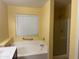 Bright bathroom featuring a soaking tub and separate glass-enclosed shower at 25798 W Miami St, Buckeye, AZ 85326