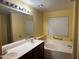 Bright bathroom featuring a double sink vanity and a large soaking tub at 25798 W Miami St, Buckeye, AZ 85326
