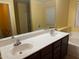 Bright bathroom featuring a double sink vanity, soaking tub and separate glass-enclosed shower at 25798 W Miami St, Buckeye, AZ 85326