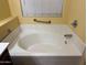 Bright bathroom featuring a relaxing soaking tub and safety bars at 25798 W Miami St, Buckeye, AZ 85326