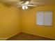 Bright bedroom with ceiling fan and window with natural light at 25798 W Miami St, Buckeye, AZ 85326
