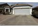 Spacious driveway leading up to the attached two-car garage in front of house at 25798 W Miami St, Buckeye, AZ 85326