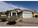 Charming single-story home featuring desert landscaping and a two-car garage at 25798 W Miami St, Buckeye, AZ 85326