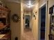 Hallway with neutral tile floors and decorative walls in the interior of the home at 25798 W Miami St, Buckeye, AZ 85326