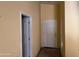 Hallway featuring a tiled floor and convenient access to multiple rooms at 25798 W Miami St, Buckeye, AZ 85326