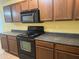 Functional kitchen featuring dark appliances and ample counter space at 25798 W Miami St, Buckeye, AZ 85326