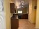 Spacious kitchen with dark wood cabinets and direct access to an eat-in area at 25798 W Miami St, Buckeye, AZ 85326