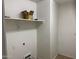 Compact laundry room featuring practical shelving and utility hookups at 25798 W Miami St, Buckeye, AZ 85326