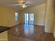 Well-lit living room with wood floors and sliding glass doors to the backyard at 25798 W Miami St, Buckeye, AZ 85326