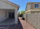 Home exterior showing side yard with gravel, block wall, and covered patio at 25798 W Miami St, Buckeye, AZ 85326