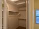 Spacious walk-in closet featuring built-in shelving for ample storage in the home at 25798 W Miami St, Buckeye, AZ 85326