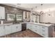 Bright kitchen featuring modern appliances, white cabinetry, bar seating, and access to the outdoors at 2595 E Harrison Ct, Gilbert, AZ 85295