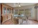 Bright breakfast nook features Saltillo tile, a glass table, and plenty of windows with tree views at 2644 E Kelton Ln, Phoenix, AZ 85032