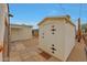 View of the outbuilding featuring a neutral color scheme and a decorative hinged door at 2644 E Kelton Ln, Phoenix, AZ 85032