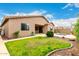 Well-maintained backyard with lush lawn, patio, desert landscaping, and inviting private pool at 27204 N 86Th Dr, Peoria, AZ 85383