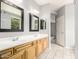 Bathroom featuring a double sink vanity with tile flooring and ample counter space at 27204 N 86Th Dr, Peoria, AZ 85383