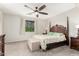 Serene bedroom with a four-poster bed, soft carpet, neutral walls, and a ceiling fan at 27204 N 86Th Dr, Peoria, AZ 85383