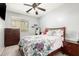 Cozy bedroom with a ceiling fan, window, and dresser, offering a comfortable retreat at 27204 N 86Th Dr, Peoria, AZ 85383