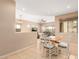 Inviting dining area with a wooden table, white chairs, and bright natural light at 27204 N 86Th Dr, Peoria, AZ 85383