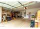 Spacious garage with epoxy flooring, overhead storage, and organized shelving for tools and supplies at 27204 N 86Th Dr, Peoria, AZ 85383