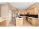 Bright kitchen with an island, stainless steel appliances, black backsplash, and tile flooring at 27204 N 86Th Dr, Peoria, AZ 85383