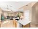 Open kitchen featuring an island with light countertops and stainless steel appliances at 27204 N 86Th Dr, Peoria, AZ 85383