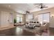 Inviting living room featuring hardwood floors, ample natural light, ceiling fans and neutral decor at 27204 N 86Th Dr, Peoria, AZ 85383