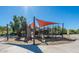 Community playground featuring a slide, rock climbing wall, and shaded play area at 27204 N 86Th Dr, Peoria, AZ 85383