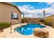 Inviting private pool with rock accents, patio space, and lush landscaping for outdoor enjoyment at 27204 N 86Th Dr, Peoria, AZ 85383