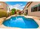 Inviting private pool with rock accents, patio space, and lush landscaping for outdoor enjoyment at 27204 N 86Th Dr, Peoria, AZ 85383