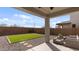 A covered patio featuring stylish wicker furniture and a view of the manicured backyard at 2855 E Tina Dr, Phoenix, AZ 85050