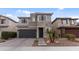 A modern two-story home with a stone facade, well-manicured landscaping, and a two-car garage at 2855 E Tina Dr, Phoenix, AZ 85050