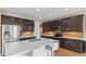 Modern kitchen features stainless steel appliances, dark cabinetry, and a large island with seating at 2855 E Tina Dr, Phoenix, AZ 85050