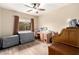 Bedroom featuring ceiling fan, desk, and natural light at 2878 E Tonto Dr, Gilbert, AZ 85298