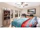 Bedroom with desk, bookshelves, ceiling fan, and cozy decor at 2878 E Tonto Dr, Gilbert, AZ 85298